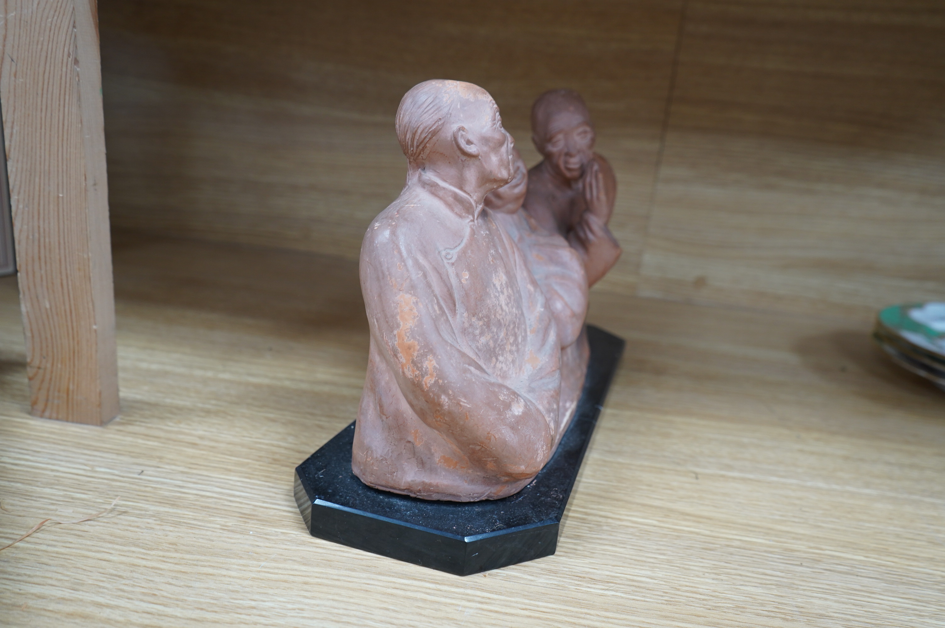 A French Art Deco terracotta sculpture of three seated Asian gentlemen, signature near base, 35cm high. Condition - fair